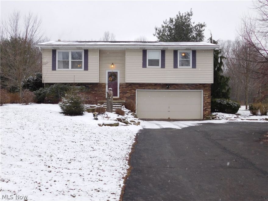 Updated, move-in ready home located on a nearly 3 acre lot in Ravenna.  The open kitchen and living room is the ideal situation to never be left out of the conversation.  The kitchen, recently renovated in 2015, boasts attractive cabinets, granite counters, and center island with breakfast bar.  Sit and enjoy meals at the kitchen table as you gaze out the slider overlooking the deck and rear grounds.  Also on first is a large updated full bath and three bedrooms including master large enough for king bed and whole furniture set!  Each bedroom has their own thermostat to set to your level of comfort. Enjoy the cozy heat without the high end costs since this home also features a wood burning stove in lower level.  Also in the lower level is a family room (perfect for work out room, home office or playroom), large laundry, half bath, and second foyer off garage.  Look forward to warmer months ahead to entertain on the deck, frolic in the pool (with newer liner 2014), or run around the hug