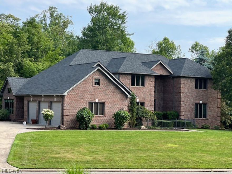 Stunning, Brick, 2 story home with 6 bedrooms and large private yard with In-Ground Pool is the one you've been waiting for! Enjoy over 6600 Sq Ft of living space with a first floor master bedroom. Beautiful Hardwood Floors as you enter the home connect the Kitchen and large Dining Area. The hardwood floors continue to a first floor Office and Sun Room overlooking the gorgeous backyard. Custom Built Gourmet Kitchen with granite countertops, 2 Islands (one with seating area), and tons of storage! Huge great room open to the kitchen features a see-through fireplace between the rooms, gorgeous custom windows overlooking the backyard, 2-Story vaulted ceilings, and double doors to the back patio. The master bedroom is one of two bedrooms on the main level, each with a full bath. Four bedrooms upstairs with 2 full baths. Outstanding, Private backyard with large patio, firepit, in-ground pool and wooded area that backs up to Boardman Park. Complete privacy with mature trees all around, you'll forget you even have neighbors! Fully Finished Basement includes a wet bar, exercise area, theater room and bonus room with a full bath in the basement that could also be an extra bedroom in this incredible estate. Tons of storage space plus an oversized 3 car garage make this the perfect home. This stunning property convenient to all the shopping and restaurants in Boardman will not last long!