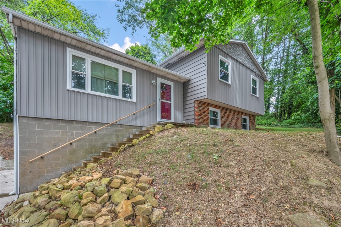Welcome to 412 Stevenson Ave located in the beautiful Ellet neighborhood of Akron! Situated on a scenic lot at the crest of a hill, offering a beautiful view & tons of privacy. In addition this home offers a total of (4) parcels. This split level gem features a spacious layout that includes a totally updated eat-in kitchen with new cabinets, countertops, flooring, lighting with all appliances included. The cozy & tastefully decorated living room & lower level family room offers the perfect layout for everyday living & entertaining. (3) spacious second level bedrooms offer plenty of closet space & ceiling fans in each room. The large main bathroom has been updated with modern features, fixtures, flooring & double vanity sink. The lower level laundry room is neat & organized & offers even more storage options. The (2) car side entry garage also has storage space & leads to a large private backyard with a deck & wooded rear view, ready for relaxing during our beautiful summer & fall nights. Additional updates include, electrical,
roof 2024, all new windows (2025) entire home exterior vinyl siding (2025) interior & exterior of home freshly painted (2025)
some updated gutters, updated hot water tank & furnace. The work has been done, this turn key home is ready to move in & enjoy! Don't' miss the opportunity to call this home!