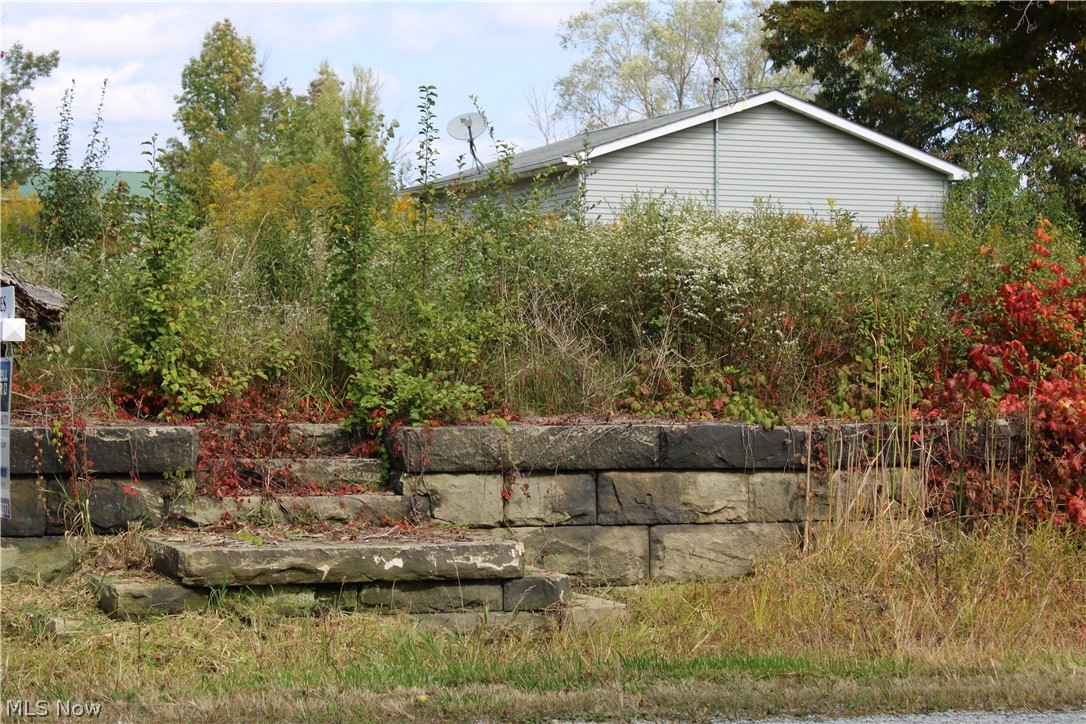 Fantastic property with lots of possibilities. Gravel drive to 64 x 40 pole barn, with concrete pad, electric and water. Concrete drive to 32 x 24 three car garage with concrete pad, electric and water. Existing well and septic system from former home that was on the property are still there and were functioning at the time of the demolition of the house. Home has since been razed and the old foundation has been filled in. There is also a small outbuilding that was used for waiting for the school bus. (House was thought to have burned down in 2014, but that is not guaranteed to be accurate information.) There are two driveways on Porter Road to this property.