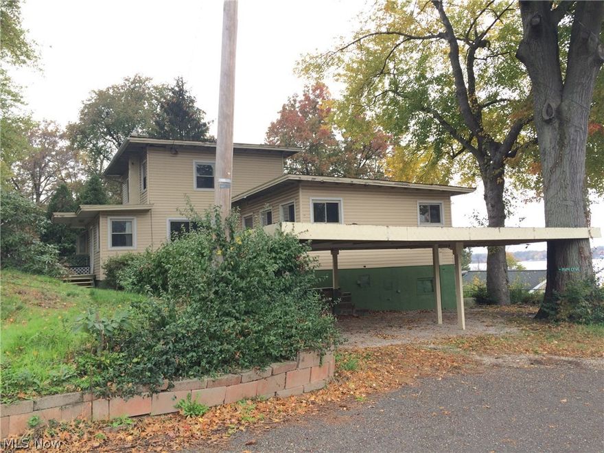 Very Unique Lakemore Home.  This home offers three bedroom 1.5 bath and a first floor laundry. It sits high up giving it a gorgeous view of the Springfield Lake. Nice size rooms. Walk out basement, patio, C.A. and workshop.