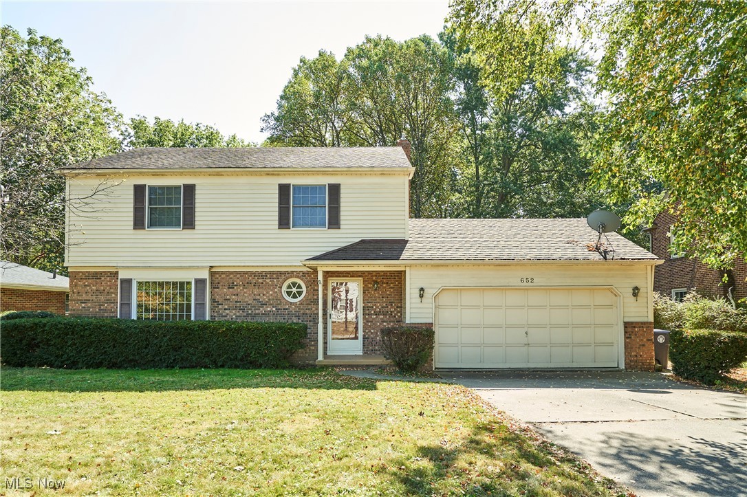 This 4-bedroom, 3.5-bath home offers classic charm, a functional layout, and a peaceful wooded backdrop. Located in a desirable neighborhood, it’s ready for you to move in and make it your own. Step inside to find a welcoming foyer that leads to a large living room and a formal dining room, both featuring beautiful herringbone wood floors and elegant trim details. The kitchen features stainless steel appliances, fresh white cabinetry, and a center island with plenty of prep space. Sliding doors off the eat-in area open to a spacious deck overlooking the backyard. A bright family room with large windows and a walkout to the patio makes entertaining easy, while a convenient half bath completes the main level. Upstairs, you’ll find four generous bedrooms, including a primary suite with a private full bath. An additional full bath serves the secondary bedrooms. The lower-level walkout basement adds even more living space with a rec room area w/ wood-burning fireplace, storage, laundry, and a second half bath. Outside, enjoy the deck and patio spaces with a private, tree-lined backyard—perfect for gatherings or quiet evenings at home.
