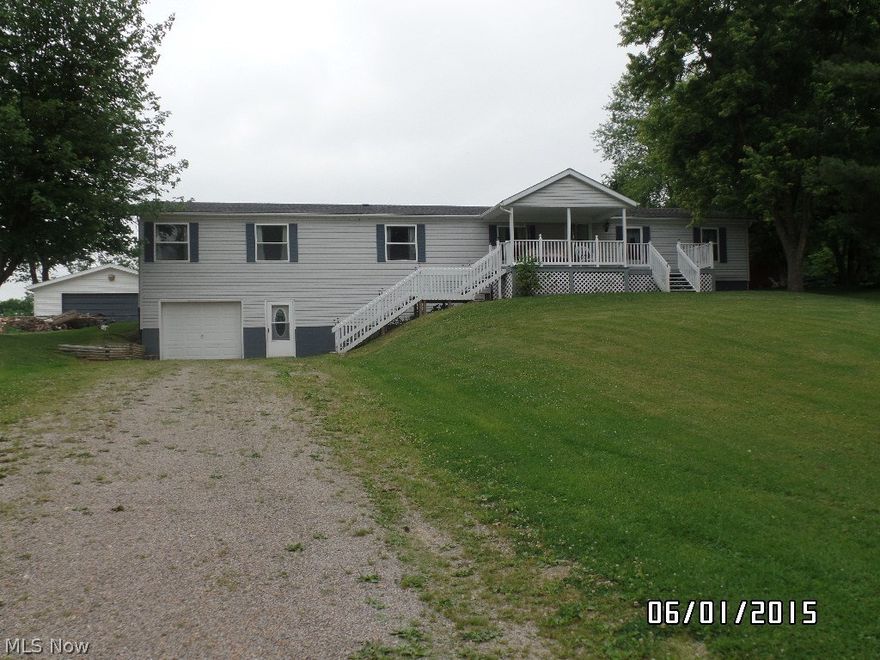 Amazing space in this home with 2052 sq. ft.!  Fully applianced kitchen which opens to family room with fireplace.  Every room is oversized, even the laundry/mud room can hold a table, plus washer/dryer set remains with home.  All walls are drywall.  Many updates including roof and skylights replaced in 2011, new rear covered deck in 2011, newer carpet throughout, and freshly painted.  Full, walk out basement with a one car garage, plus a 2 car detached garage.  There is also a 2 bedroom single wide mobile home at rear of property (conventional buyer only). Five beautiful acres and a large covered front deck!  You will not be disappointed!