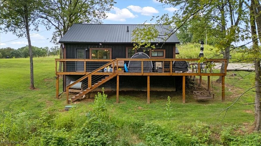 Nestled on a beautiful 2 acre lot and built in 2023, this 2 (possibly 3) bedroom cottage offers a perfect blend of modern style and rustic charm. Step inside to find vaulted ceilings, an open living area, kitchen with stainless appliances and a wonderful loft (or 3rd bedroom) space. The bathroom feels like a retreat with a walk-in shower, soaking tub and large picture window overlooking the lush landscape. The oversized deck expands your living space outdoors and is perfect for grilling, entertaining or simply relaxing while taking in the views. Located just minutes from town, yet tucked away for peace and quiet, this property makes a wonderful full-time residence or weekend getaway.