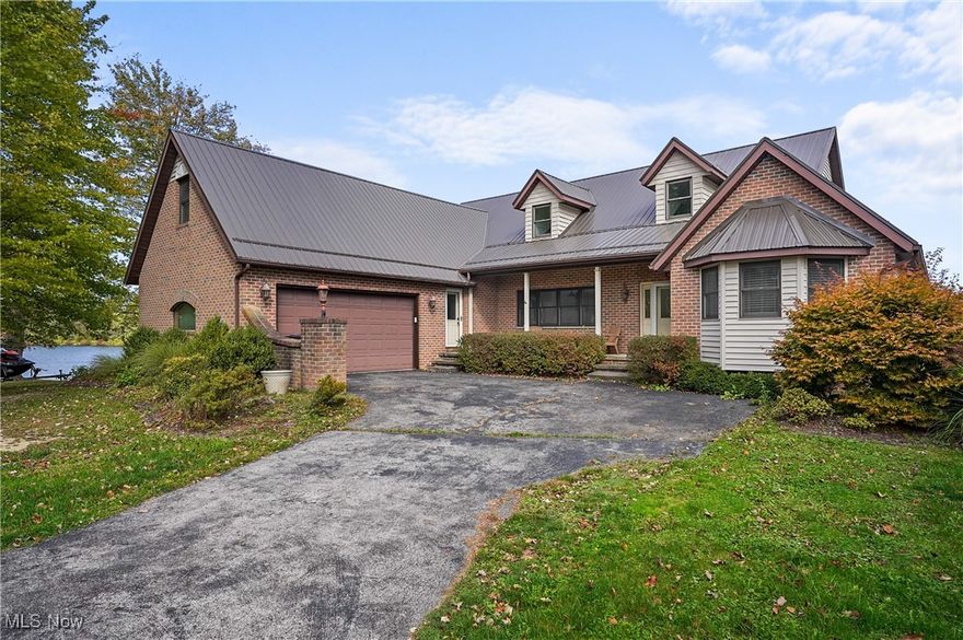 Snag this stunning lakefront home in time for winter sports and get it ready for summer lake living. Roaming Shores is the largest private lake in Ohio and is a community of affluent boat/lake enthusiasts and part time lake lovers. Only residents and guests are permitted to use the lake. There are 3 bedrooms on the first floor, a separate office, along with an upstairs with 2 more bedrooms, and a walkout basement with a separate kitchen, having space to entertain family and out of town friends, space will never be an issue. Sitting on the tip of a small peninsula, lake views are visible from most of the windows.  The center of the home features a spacious family room with a fireplace and sliders to a deck overlooking the lake. French doors lead to an office with a wall of windows. Two bedrooms flank one side of the first floor with the primary on the opposite side with a private deck off sliders for morning coffee over water views. The gorgeous eat in kitchen features Cherry cabinets and granite counters, center island.  Downstairs is a mostly finished, walk-out basement with another full kitchen and family room and full bathroom,  perfect for guest quarters and visits, or turn it into a family room. Massive storage areas are also in the basement which could be converted to many useable living spaces. Upstairs are two bedrooms, each with private bathrooms and each with amazing views of the lake. There is a newer metal roof. Situated close to a popular local restaurant, marina and at the end of a quiet cul-de-sac, this prime location can now be yours. Please view the 3D tour included above to truly see all the rooms and layout. Visit the Roaming Shores page for event announcements such as wine bus tours, Santa, pickle ball club, fishing club, polar bear club, and many other neighborhood events! They also have a hall for rent and 2 swimming pools, adult and kids, along with beaches. Seller willing to give flooring allowance with suitable offer.