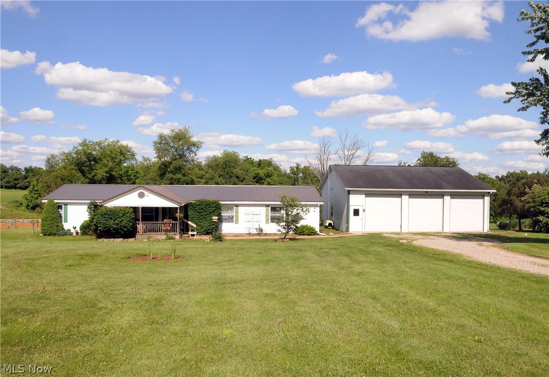Beautiful 5 acre country setting showcases this 3 BR, 2 BA modular w/ lg 3 bay detached new metal roof (2019) pole barn. Cozy covered porch-deck. Completely updated kitchen w/ new black stainless steel appliances. Butcher block tops w/ farm sink. Public water, great garden spot.