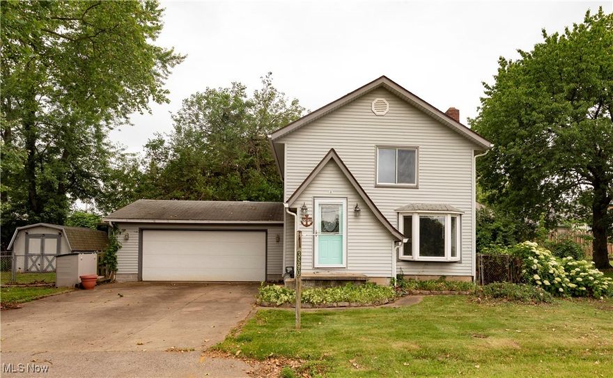 Location, location, location!  Enjoy a 5-minute walk to the waterfront in the heart of Portage Lakes.  This unique 3 bed, 1 bath colonial is waiting for you.  Inside, you’re greeted with a large living room with LVP flooring and tons of natural light.  The kitchen features an island, shiplap paneling, stainless steel appliances, and new countertops and sink (2025).  Entertain year-round in your sunroom with floor to ceiling windows and gas heater.  Store your boat and car in the spacious 2 car attached garage.  Gather friends and family for a BBQ out back in your fenced-in back yard with gated access to Portage Point Blvd.  Some updated include landscaping (2025), new high efficiency furnace (2025), vinyl siding, glass block windows in basement and double pane vinyl windows in remainder of home.  Just minutes from all the fantastic restaurants, grocery stores, and public boat ramps of Portage Lakes.  Grab your fishing pole then call your favorite Realtor today and schedule a private showing!