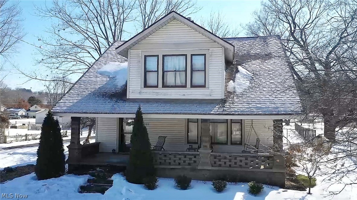 Welcome to this charming and well-maintained century home. Lots of character, spacious, original craftsman-style woodwork, hardwood floors, bright, many windows, and an airy feel from the moment you enter this lovely home. The great room has beautiful pocket double doors to the formal dining room on the main level. The eat-in kitchen offers appliances, a dinette area, a mudroom with a walkout to the deck, and a convenient updated full bath with tile surround walk-in shower & a fantastic deluxe full-body shower system. The main floor also has an office with many windows, an abundance of natural light, and a closet. The second level features four bedrooms and a full bath (two bedrooms have walk-in closets). The basement could be easy to finish into a living area/rec room and has glass block windows, a wood-burning stove, a shower, a laundry area, and plenty of storage space. Relax in the shade on your 12x20 rear deck with a fenced-in private backyard or your covered front porch. There is