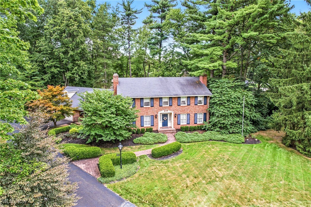 Stately 5-bedroom brick colonial in the desirable Country Club Estates! The sprawling floor plan features an impressive foyer situated between the formal living, dining room, & family room with architectural detail such as wainscoting & hardwood floors. A dream kitchen boasts double wall ovens, an electric cooktop & granite countertops with a large center island. The casual dining space has access to an expansive brick sunroom that features all-new windows & doors that lead to a large custom-built deck with a built-in gas grill. A floor-to-ceiling brick fireplace is the focal point in the family room, which also has a custom-built-in wet bar. An office with built-in cabinetry, laundry room & half bath complete the main level. A beautiful staircase leads to the 2nd floor where you'll find all 5 generously sized bedrooms including a master suite ensuite with double closets & a completely remodeled luxury bathroom with walk-in shower & double vanity! Each secondary bedroom has amazing closet space & access to 2 additional full baths. A bonus area above the garage is a wonderful space for storage. The finished lower level adds a fantastic rec room with a fireplace, and a space designed for workout equipment, pool table, & loads of storage. The amenities continue outside with a spacious brick patio & a private wooded lot. The 2.5 car side load garage provides ample room for your cars, outside toys & lawn equipment. Located in a prestigious community adjacent to the Trumbull Country Club with swimming, golf, tennis & events throughout the year! This is an exceptional home you'll want to see!