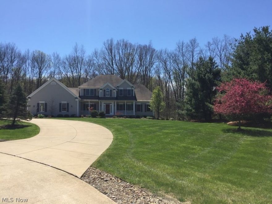 2.47 acre wooded lot on quiet cul-de-sac. 1st & 2nd floor master suites, 1st floor office, Open kitchen flows into great room; great for  entertaining. Rear two-tier deck close to woods provides privacy, (another private deck off great room). Finished walk out basement has kitchenette (dishwasher, microwave/convection oven); wide screen tv. Basement also boasts workout area, plenty of storage, workshop, and wine cellar. 30 minutes from downtown Cleveland/Akron; close to many amenities. Twenty minutes to Hopkins Intrl.