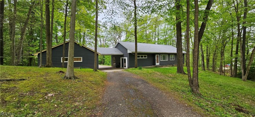 Enjoy this secluded oasis in the city!  This 3 bedroom, 1 bath ranch home is nestled away among the trees on a 1.2 acre corner lot, with the convenience of one floor living and the great outdoors wrapped into one in this rare find.  The large bonus room is sure to please, serving as a 3-season room, sunken family room or rec room - whichever you choose, it will undoubtedly be a favorite resting place.  The oversized 30x24 garage is great for a mechanic or hobbyist too.  Additional amenities include hardwood floors throughout, a partially finished basement, and many recent updates including appliances, patio door, carpet, electrical service, hot water tank and roof in the last few years.  This hidden gem is just waiting for your personal touch - call today!