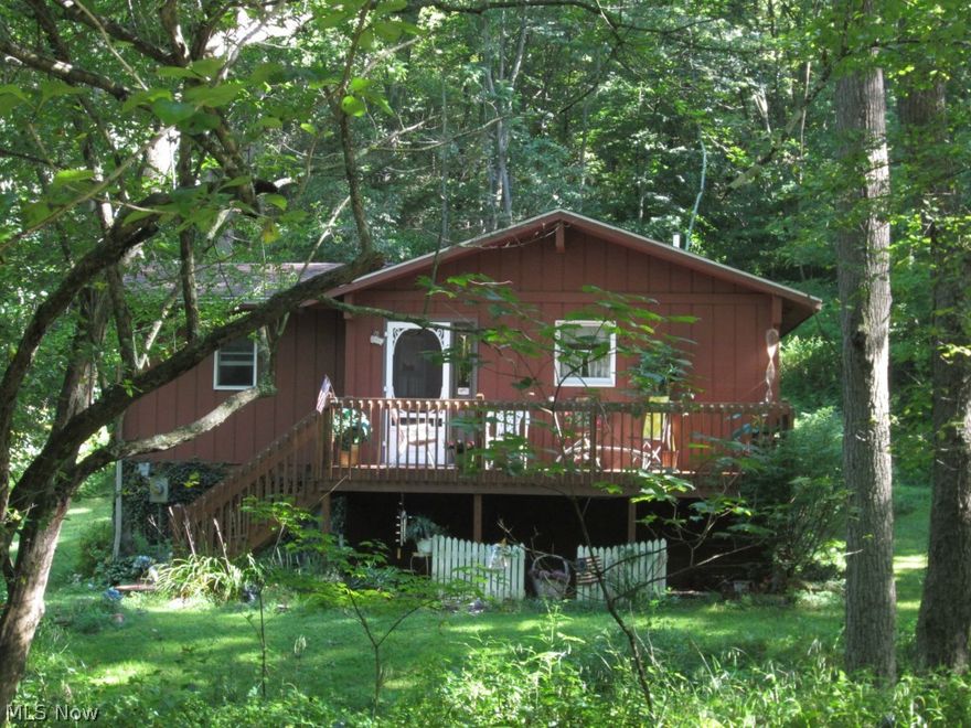 Adorable cottage on a very secluded private road.  Home sits on 1.24 acre and is surrounded by trees and wildlife.  Home is nestled between beautiful wild flowers and mature tree.  Exposed stair case adds the perfect touch to this cottage.  Finished room in the basement could be used at 3rd bedrm or additional entertainment space.  Kitchen appliances will stay with new owner.  Home offers central air!  Great front porch to relax and enjoy the country life!