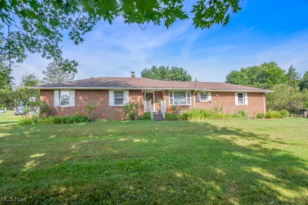 You’ll feel right at home in this spacious all brick ranch in Manchester Schools! With over 1800 square feet, there’s plenty of room for everyone. A brand new front porch adds great curb appeal, along with new front and back doors that offer peace of mind and a fresh look. Inside, the living room is filled with natural light from a skylight and features a fireplace and hardwood floors that flow into the dining area. The kitchen has space for casual meals, matching white appliances that will stay, lots of cabinet storage, and a brand new floor. Down the hall, the primary suite includes its own full bath, while two more comfortable bedrooms share a full bath with vintage tile. The full basement was previously waterproofed and has a second fireplace, perfect for future finishing. Sitting on a 3/4 acre corner lot, you’ll also enjoy a 2 car side load garage, a big yard with a shed for outdoor tools plus leaf guard with a lifetime warranty. Great location close to parks, Portage Lakes, and major roads. Come take a look!