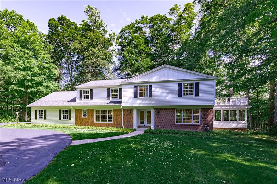 Enjoy your own private nature preserve with this fantastic Moreland Hills colonial on two and a half acres of wooded bliss!  Meticulously maintained and continuously updated by the seller over 36 years of ownership and ready for the next owner to love!  The entrance has a newer front double door in the ample sized front foyer with a convenient 1/2 bath.  Formal DR with built-ins and buffet counter to the left and large living room with FP to the right both boast beautiful hardwood flooring.  Off the LR might be your favorite room, a sun room with brick floor and wood ceiling surround by the sounds of nature..newer windows & slider to rear brick patio!  The updated kitchen with natural wood cabinets, cherry wood flooring, granite counters, and new s/s appliances (2019) opens completely to the FR with curved brick FP and newer slider to the patio!  Also on 1st, awesome mud/laundry room with tons of cabinets, granite counters and 2nd private commode.  Upstairs, four wonderfully sized BRs