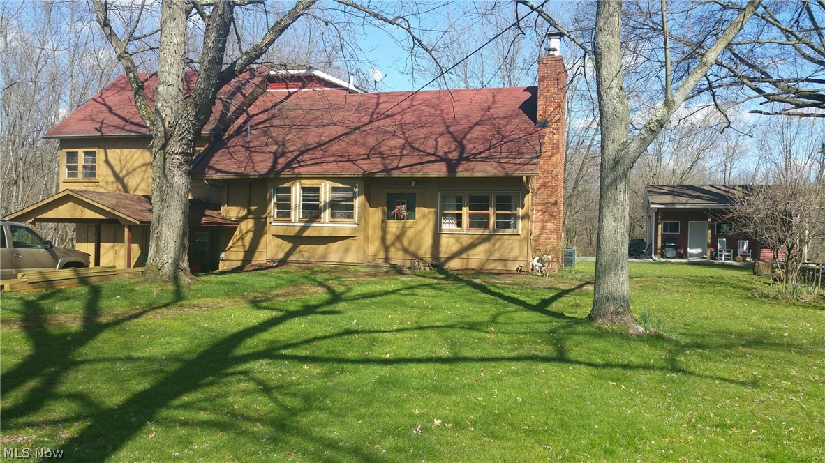 Tons of character in this updated Tudor style farmhouse. This unique 4 (possibly 5) level split has plenty of room and storage! Enjoy 4 bedrooms, 2 bathrooms, open main floor-plan, gorgeous fireplace, hard wood flooring, stunning exposed beams, all new kitchen (appliances stay!), new bathroom with separate tub & tile shower, huge master bedroom, 18x25 outbuilding with covered porch, basketball court and so much more in the beauty! Private wooded 3.58 acres is perfect for entertaining, family cookouts, children and pets! Move right in and start your summer off with strolls on the trails through the woods, enjoy fruit trees and have bon fires in the fire pit. Many major updates have been completed already... Newer furnace and a/c, new well pump and more updates including a new roof, new gutters and new siding are in process. This is a true gem for the savvy buyer. Sellers are sad to sell due to a job relocation. Located close to shopping, dining, parks, schools and the highway! Schedule