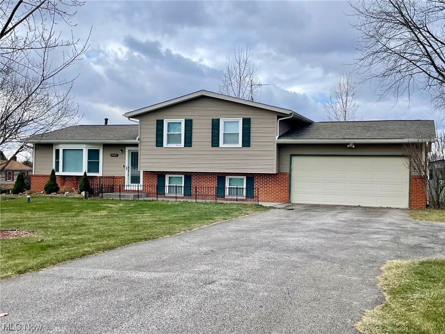 Spacious split level located in the Lake Local School District! This 4-level split with attached two car garage sits on a 1/2 acre lot with a large backyard, shed, garden area, and extra parking.  The main floor has an abundance of natural light coming from the sizable living room windows which then flows to the eat-in kitchen with sliding doors and composite deck.  A few steps up to the second level, you will find a generous sized primary bedroom, 2 additional roomy bedrooms, and an updated full bathroom with a dual vanity.  Leading from the main level down a few steps, you will find a huge family room with windows, a second full bathroom, and a bonus room with windows previously used as an office. The lowest level hosts the laundry area and is unfinished for ample storage space.  Freshly painted throughout and comes with all appliances including a large deep freezer!