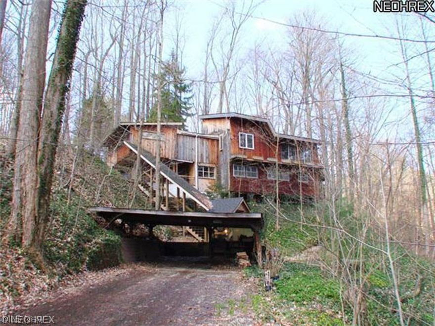 Very unique home surrounded by nature built high on a hill overlooking a ravine!  Beautiful entryway with spiral staircase to the lower level!  Great room with stone fireplace and deck access.  There is a loft directly above the dining room that has endless possibilities!  Large master bedroom on first floor with full bath that has been updated!  The lower level has three additional bedrooms and one full bath and plenty of storage space!  The side deck offers beautiful views!  This is a Fannie Mae HomePath property.  All information is approximate.
