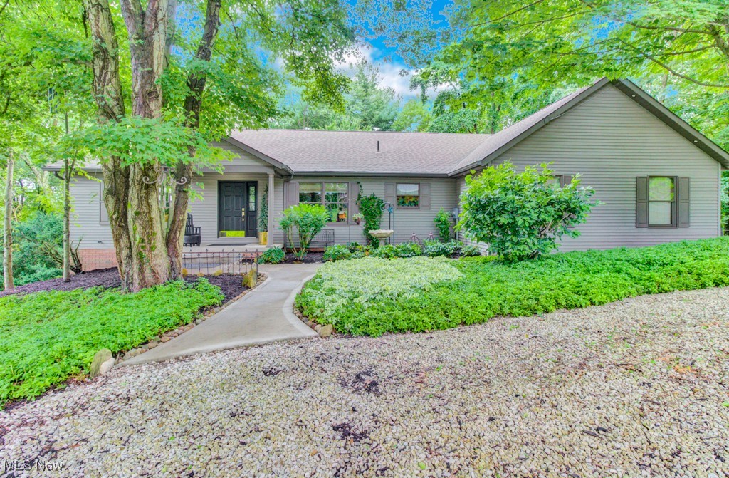 Tucked away in the trees on two beautifully wooded lots at Lake Mohawk, this breathtaking ranch home offers a one-of-a-kind retreat! Step inside to cathedral ceilings, rich hardwood floors (2012), and a cozy wood-burning fireplace. The heart of the home features a custom kitchen island made from an antique workbench, granite countertops, and solid oak doors—every detail thoughtfully curated, including a stunning handmade light fixture crafted by a local blacksmith.
The main floor offers convenience and charm with a spacious laundry room (utility sink included), a sunroom with a wall of windows, and access to the expansive Trex deck (2019) that wraps around the home—perfect for outdoor entertaining. The private primary suite features French doors (2023) leading to its own deck, double closets, dual sinks, a garden tub, walk-in shower, and skylight for natural light. Additional updates include: refrigerator (2023), microwave (2024), driveway and sidewalk (2023), and soffit lighting that adds evening ambiance. Downstairs, enjoy a full walk-out lower level with a bedroom, full bathroom, additional living space, and a generous storage room with built-in cabinetry and two access points. The sidewalk leads to a peaceful lower patio area, ideal for quiet mornings or cozy gatherings. An oversized two-car garage completes this amazing home—designed for comfort, character, and connection to nature. Don’t miss out on this amazing opportunity at Lake Mohawk. Lake Mohawk is a private gated community with an unlimited horsepower 500 acre lake, three scenic beaches, an executive 9-hole golf course, tennis & pickleball courts, and so much more!