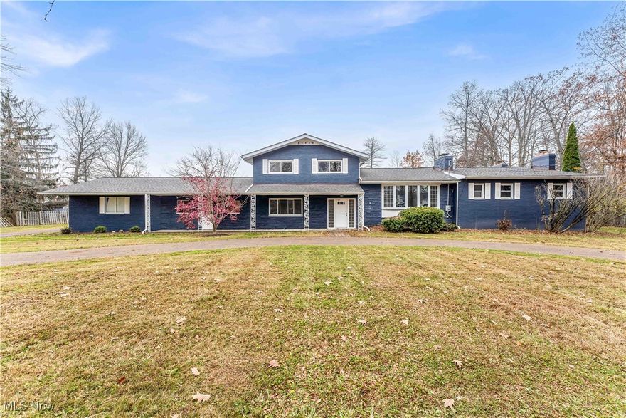 Stunning, fully renovated split-level home on over an acre in Hudson! This exceptional property combines modern design, high-end finishes, and spacious, light-filled living areas throughout! The exterior impresses with fresh slate-blue paint, a welcoming covered front porch with wrought-iron pillars, and a convenient horseshoe turnaround driveway.

Inside, discover 5 bedrooms, 3.5 bathrooms, and 4 fireplaces! The main level features a formal living room with large bay windows and a brick accent wall, plus an open-concept kitchen and morning room filled with natural light. Elegant white cabinetry wraps the space for abundant storage, complemented by granite countertops and a center island with bar seating.

A luxurious rear family room showcases a striking stone fireplace and sliding doors to the deck—perfect for entertaining or relaxing at home! The first-floor master suite includes its own fireplace, a full ensuite bath, and convenient access to first-floor laundry and a powder room.

Upstairs, find three additional bedrooms, including a large ensuite, plus a beautifully updated main bath. The lower level offers another family room with fireplace and walkout access to the patio, along with a fifth bedroom—ideal for guests or a home office.

Outside, enjoy the expansive backyard and a 4-car garage with workshop space! Recent updates include newer HVAC, roof, electrical, paint, and fixtures, making this home move-in ready. This Hudson gem offers style, comfort, and elegance—schedule your showing today because it won’t last long!