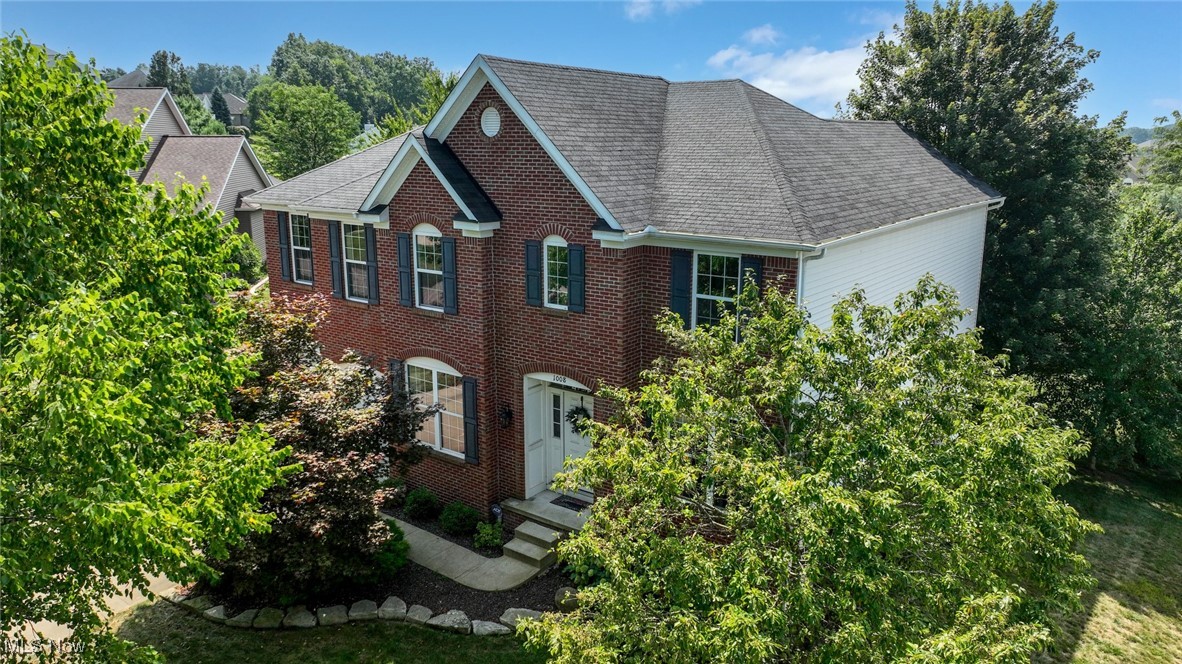 Discover a refined Colonial offering 5 BD, 4 BA, built in 2010 and sited on a quiet cul-de-sac in the Spring Hill neighborhood. Offering 4,172 square feet of beautifully designed living space, this home blends timeless elegance w/modern comfort. A classic brick and vinyl façade sets a welcoming tone, while a 2-story foyer flanked by formal living & dining rooms welcomes guests w/abundant natural light from a transom window. The open, flowing floor plan features hardwood floors and a seamless connection between formal and casual spaces. A spacious two-story Great room w/wall of windows & gas fireplace creates the perfect backdrop for gatherings. Well-appointed, the kitchen features SS appliances, a breakfast bar, granite countertops, chic glass tile backsplash, a pantry, and a breakfast area with sliding doors leading to a composite deck. Also on the main level: a versatile bedroom or private den, a convenient full bath, and a laundry room equipped with a sink hookup. The upper-level features 4 generous bedrooms, anchored by a luxurious owner's suite. The suite opens through elegant French doors into a spa-inspired bath with a corner soaking tub, oversized walk-in shower, dual vanity, new flooring and a spacious walk-in closet. Three additional BDs and a full hall BA complete the upper level. A fully finished, walk-out LL includes an expansive recreation room with a distinctive tile/stone focal wall, a newer full bath, an exercise or multi-purpose room, and ample storage. Recent upgrades include: freshly painted throughout, motorized window treatments, a composite deck, and professionally landscaped grounds featuring birches, maples, and pines, creating a beautiful, private outdoor oasis. In the highly rated Green Local School District and just minutes from schools, parks, shopping, dining, golf, and I-77, 1008 Dalby Circle is more than a home; it’s a harmonious blend of architectural elegance, luxurious living, and thoughtful functionality. Schedule a showing today!