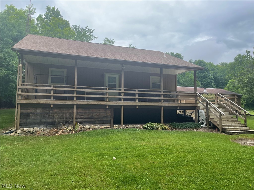 Welcome home! This well-maintained cabin in beautiful Guernsey County is the perfect place to settle down, and enjoy a piece of the good life! This cabin features an open floor plan with a newly converted loft area to accommodate additional guests. The wood burner in the livingroom is a very efficient backup heating source that features an automatic temperature-controlled blower! Attached is a 720 sq ft wrap around deck that opens up to an additional 4.75 acres of endless opportunity! With a firepit and 2 car garage on site, what else could you ask for?! Numerous updates: Roof replaced in 2014, septic pumped in 2014, kitchen and bathroom flooring recently replaced, carpet replaced throughout, expansion tank and electric water heater newer. This property WILL NOT LAST so schedule your showing today!