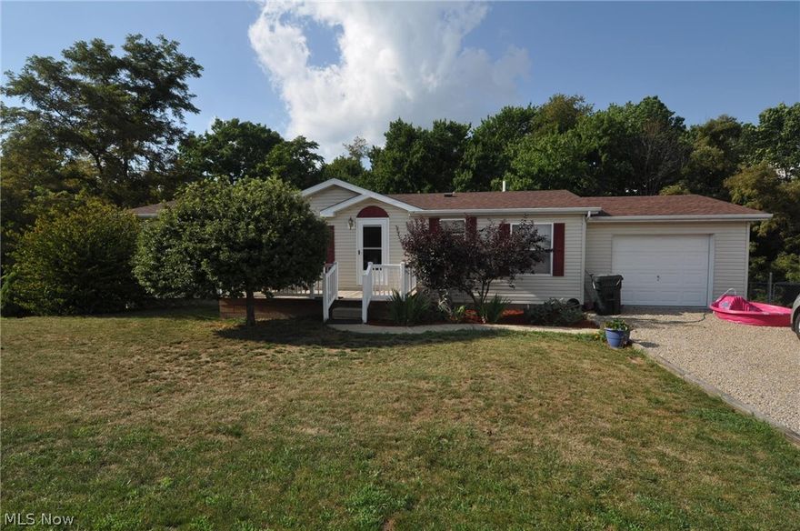 Manufactured home with nice size living room, eat-in kitchen with range and refrigerator, three bedrooms and two full baths, including master suite with walk in closet,  bath with garden tub and separate shower, double sinks, newer vinyl tile flooring, first floor laundry room.  Owner finished a family room in the walk out basement since purchasing this home, 24' x 29'7", which has outlets in the ceiling for ease in plugging in T.V., and supporting electronics, a slider door to the chain link fenced in back yard.  Chain link fence has three gates, one large enough to get a truck into the back yard for ease in bringing items into and out of the basement. Large storage area in the basement, 13.5 x 29.7 with carpeted floor, or could be finished for additional living area.  Updates include family room addition in basement, roof shingles in 2013, laundry room sink, fenced back yard, newer garage door opener, water heater less than two years old, plumbing for laundry newer, newer vinyl tile