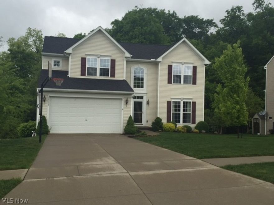 Spacious 4 bedroom home in Tinkers Green Subdivision. This open floor plan provides lots of living area. The huge eat in kitchen with a wall of windows overlook a beautiful wooded ravine. The view fully captures the four seasons backdrop to your dining! This subdivision offers beautiful walking paths in your own back yard!  A marvelous wood deck provides outdoor enjoyment. The deck has built in flower boxes and  stairs down to a very well maintained yard. Front and side lawn is plush sod and both back and front lawn has a sprinkler system! Great room has a stone front fireplace and plenty of windows, and newer carpet. Kitchen is endless and has extended island and ongoing cabinet space and a large pantry. Master bedroom is enormous and has large walk in closet and big master bath. Three additional bedrooms and second full bath complete the upstairs. Landscaping surrounds this well maintained home. Central air conditioning.  Walk out full unfinished basement with rough in for toilet. Cl