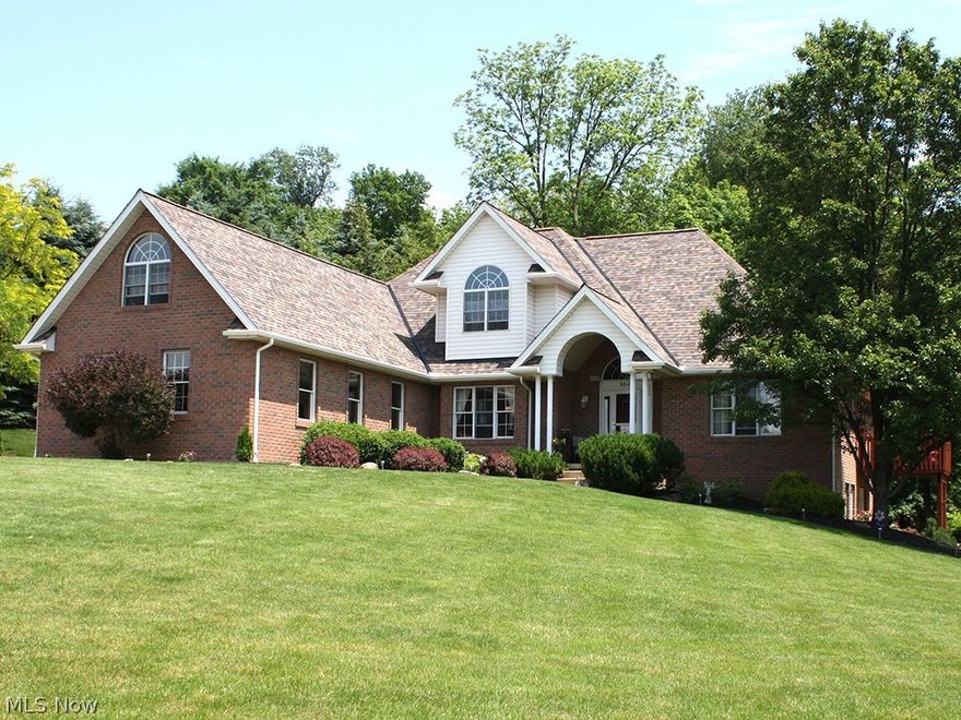 Welcome Home! This stunning brick home with 3 car garage sits on a corner wooded lot with private park-like setting. Home features new 50 yr roof, gutters, gutter guards, furnace, a/c & hot water tank (2017). NEW Hardwood floors throughout living, dining and bedrooms. Kitchen was recently remodeled and features tile flooring, stainless appliances, granite counters, under cabinet lighting, recessed lighting, slider to deck and large window over sink. First floor master bedroom features cove ceiling, crown molding, wood floors, slider to deck, large walk-in closet and large windows. Master bath boasts, granite double vanity, large walk-in shower, jetted tub, built-in granite vanity & more! Finished lower level features full bathroom and french doors open to patio. Large first floor laundry/mud room. Living room features wood floors, surround sound and gas fireplace. Dining room with tray ceiling, crown molding, chair rail and new light fixture.