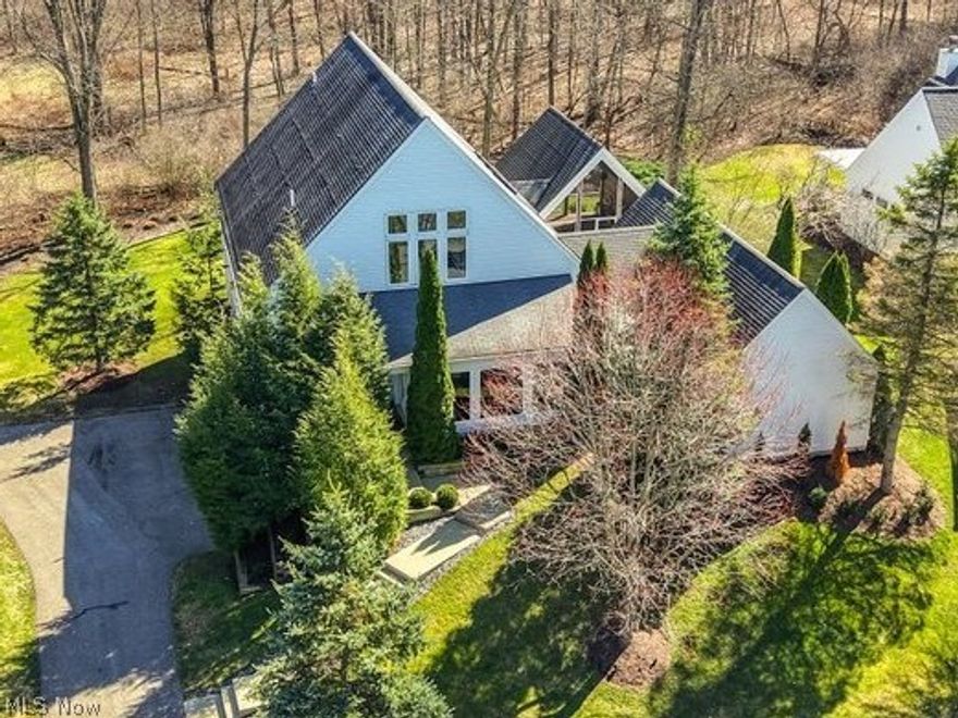 Welcome to Walden Farm Estates. Perched on .65 acres of rolling hills with mature evergreens and surrounded by acres of wooded forest, this is the ultimate private sanctuary for all seasons! Professionally designed for one floor living with primary bedroom and laundry room on the main floor, 2 guest bedrooms on the 2nd floor, a complete lower level with a fourth bedroom with ensuite bath, a large theatre/game space and a 3-car garage. The property offers an open-concept layout with floor to ceiling windows encompassing the great room and dining area, a vaulted ceiling lanai with screened in/wood paneling directly off the kitchen and overlooking the rear of the property for entertaining and a glamping-style escape. A courtyard with firepit in the center of the home is visible from the kitchen and primary bedroom completing the sanctuary feel. This fabulous home incorporates a striking corner fireplace in the great room with two matching sitting areas flanking the main dining table, vaulted kitchen ceilings and skylights, a catwalk overlooking the kitchen, a chef’s kitchen with gray shaker cabinetry, two islands for serving and storage, a dream of walk-in pantry, and KitchenAid appliances. The vaulted primary bedroom suite features a spa bath and shower and private water closet. The second floor includes two spacious bedrooms with full private bathrooms and walk-in closets with wool carpeting. Flooring includes natural Bamboo wood and slate stone flooring on the main level and gray wool carpet in the bedrooms–all in harmony with nature! From custom lighting to all the closets you will ever need, to gorgeous natural landscaping and every architectural detail considered, it is a must see! The home has been meticulously maintained and completely refurbished with all new mechanicals including 2 HVAC–Furnace systems and a tankless water heater system. With all furniture and décor available for purchase, this truly is a one-of-a-kind turnkey opportunity not to be missed!