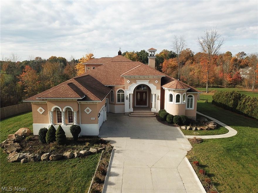 Unique, Mediterranean & Italian Renaissance styled home, characterized by the numerous arches & columns throughout the interior and exterior of this five bed/five full, two half bath “Villa-like” escape in Richfield & the award-winning Revere School District. Endless options & opportunities lie within the walls of this 5600+ sq ft home. Open Great Room w two-way gas fireplace, built-in storage, curved wall of windows, & soaring ceilings make a perfect first impression. Spacious kitchen feats 2 islands, double oven, two sinks, high top counter eating area, sliders to deck, w nearby wet bar & wine storage, walk in pantry, 2nd cooktop in adjacent laundry room, & generously sized dining area for all of your guests. First floor master suite w gas FP, slider to wrap around deck, hardwood floors, ornate arches, glamour bath, two WICs, dual sink vanity, & tiled shower. First floor also feats 2nd large bedroom w en suite, office w curved wall of windows & 3rd full bath. Second floor feats priva
