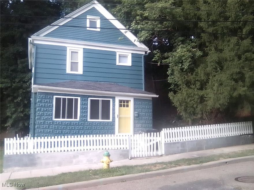 Hidden Gem! This little neighborhood tucked away on the border of North Hill and West Hill offers charm, a convenient location, and a neighborhood vibe!  The freshly painted home with a new yellow door is inviting into a freshly painted enclosed porch, which enters to a large spacious foyer. The high ceilings give the home a spacious, open atmosphere. The bright neutral colors leave limitless options for someone to bring their own decor ideas to this home. The kitchen has been updated. The three bedrooms upstairs have carpet flooring, doors, and closets. The bathroom has been updated. There is street parking, currently, the neighboring lot is owned by an Akron company and seller is negotiating with hopes to purchase. There is a driveway on the vacant lot. This home is available for a homeowner or for an investor!