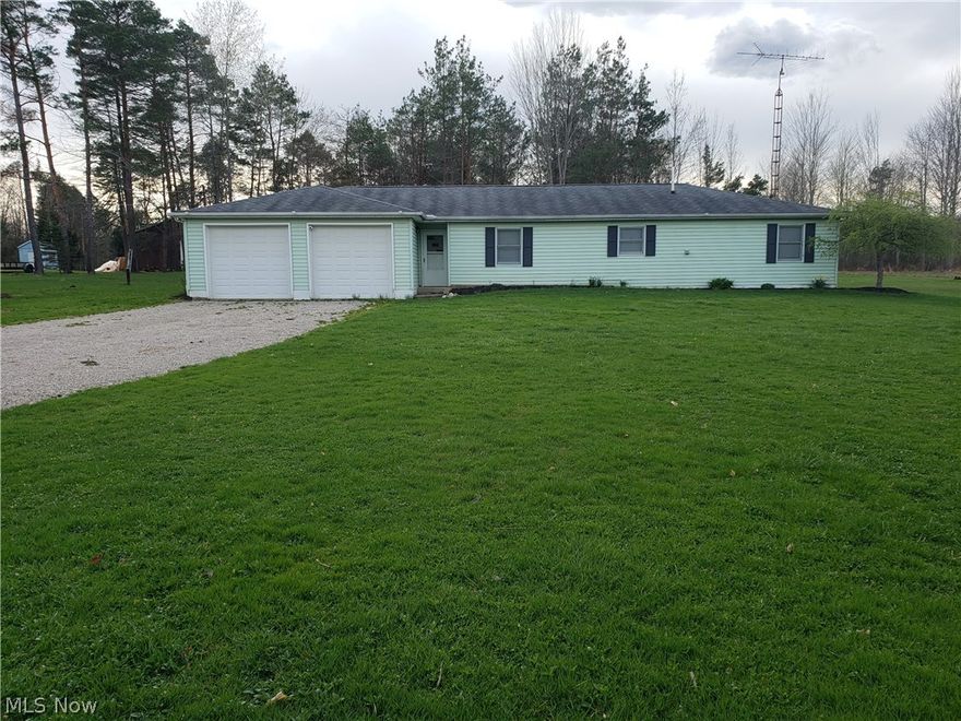 This home offers single-floor living as it is a 3 BR, 1 BA ranch home on a slab with an oversized 2 car attached garage. The living areas are open and spacious. There is a great bonus seasonal room directly off the living room that is excellent for those seasonal parties and it has direct access to the back yard. And the back yard--- 5 acres with a firepit, woods and great outdoor living!!