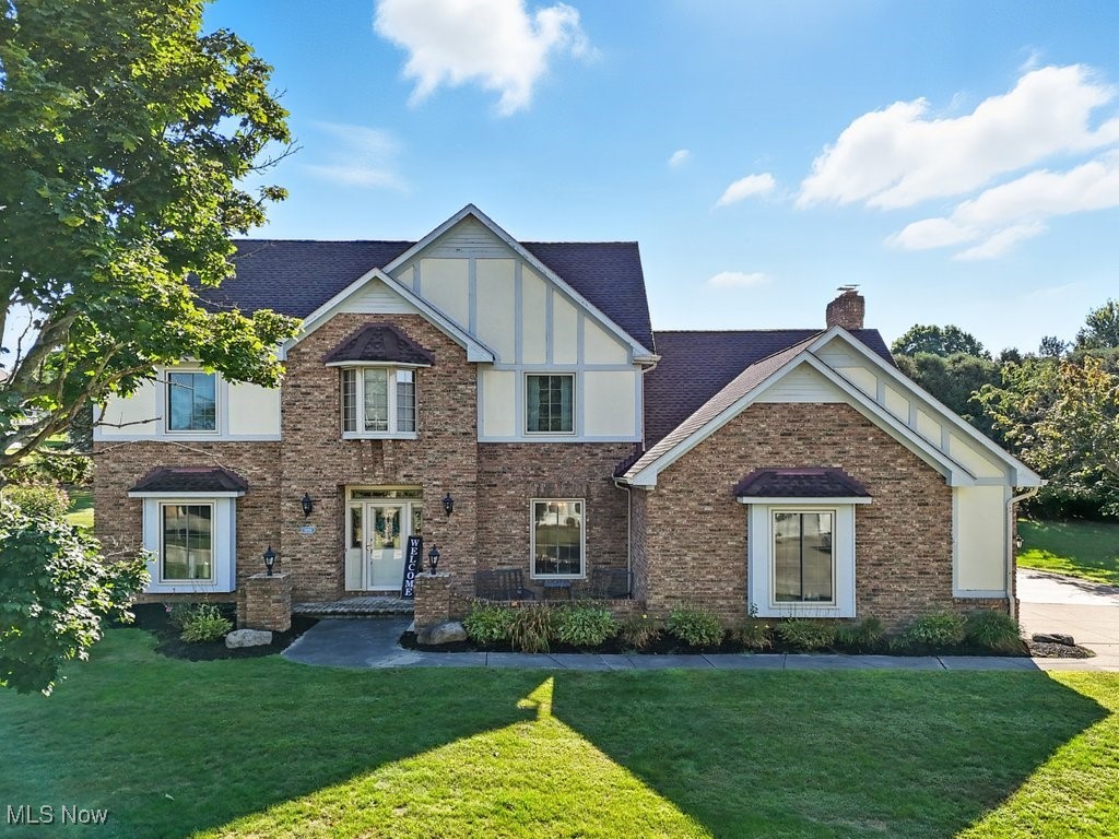 Enjoy classic charm and modern amenities in this stunning Wadsworth colonial, perfectly situated in a beautiful north end neighborhood. Exceptional curb appeal welcomes you with a stately front entrance and inviting outdoor seating area. Inside, a grand foyer with sweeping staircase sets the tone, leading to a private home office and convenient half bath. Natural light fills the open, spacious kitchen featuring granite countertops, stainless steel appliances, solid wood cabinetry, and a built-in desk area. The kitchen flows seamlessly into the cozy family room with a vaulted, wood-beamed ceiling, floor-to-ceiling brick fireplace, wet bar with wine rack, and sliding doors to the private courtyard patio. Additional main level highlights include a first-floor laundry with sink and folding counter, a bright living room, and a formal dining room—all showcasing hardwood floors, crown molding, updated lighting, and large windows. Upstairs, the owner’s suite offers a true retreat with double vanity, jetted tub, tiled shower, and water closet. French doors open to a versatile guest bedroom that could serve as a second office or nursery, plus two additional bedrooms and a full guest bath with dual sinks. The backyard is an entertainer’s dream, with a stunning brick patio nestled among lush landscaping—ideal for relaxing or hosting gatherings. A two-car garage and extra-wide driveway provide ample parking, while the full 1,600 sq. ft. basement offers endless potential with rough plumbing for an additional bath. Recent updates include roof (2019), HVAC (2022), and front windows (2024). Conveniently located near schools, parks, highways, dining, entertainment, and the vibrant Main Street Wadsworth district, this home blends timeless character with modern comfort—ready to be your home sweet home!