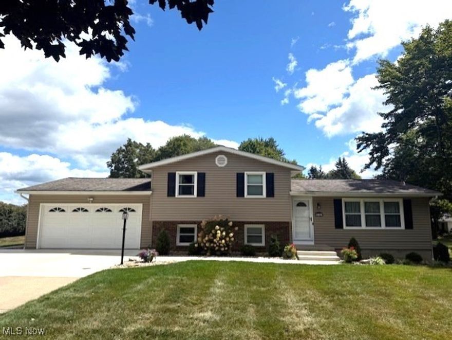 Absolutely stunning four-level split offering nearly two acres of park-like grounds—meticulously cared for by its original owner. This spacious residence features three (potentially four) bedrooms and two beautifully updated full baths, blending classic charm with modern upgrades. The inviting family room, anchored by a cozy wood-burning fireplace, flows effortlessly to the two-car attached garage—ideal for ease of access and practicality. The large, fully equipped eat-in kitchen is a true heart of the home, with sliding glass doors that open to a generous deck overlooking the lush, landscaped yard—perfect for both quiet mornings and lively summer gatherings. Recent updates throughout—new carpet and flooring installed within the last two years—add freshness underfoot. The home’s investment in essential systems is impressive: a new dishwasher (2025); central air (2023); reverse osmosis system (2024); water softener (2022); furnace (2019); hot water tank (2021); plus updated windows, exterior doors, and siding (2010–2012); and a roof installed in 2014. Even the garage sports a brand new concrete floor, and fresh concrete sidewalks and a partial driveway were poured in 2025, along with an updated panel box. Outside, you’ll discover a spacious 34' × 24' pole building with a 10-foot tall garage door and a 7-foot side door—ideal for storing a boat, camper, or multiple vehicles. This home is truly move-in ready—don’t miss your chance to experience its thoughtful layout, thoughtful upgrades, and serene outdoor setting. A rare opportunity for both comfort and convenience on a beautiful property.