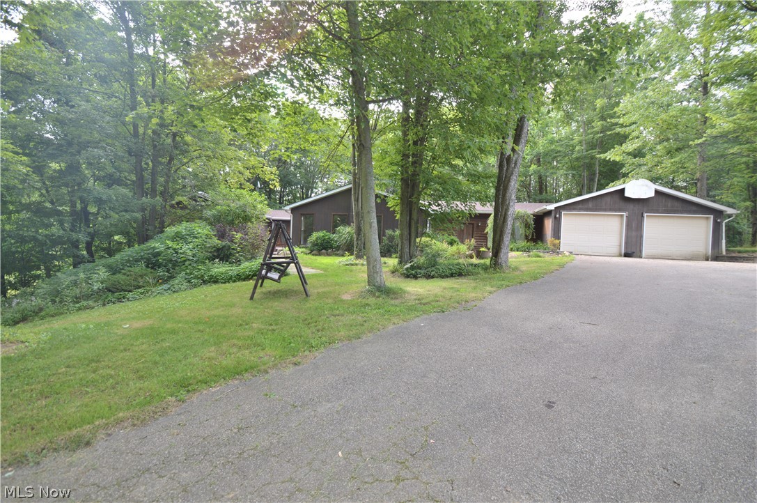 Beautiful country 3 bedroom, 3 bath ranch home sitting on 10+ acres in Springfield School District. This large open floor plan features an impressive great room with new High Valley wood burning stove and stunning hard wood floors. The large kitchen with custom breakfast bar island is open to the dining area - fit for a farm house table and lots of family. Continue through to a sunny sitting room - could also be a nice office space - and three nicely sized bedrooms one of which is your master suite. First floor laundry and one full bath is tucked conveniently behind the kitchen. You'll find more living space featured in the lower level, with walk out basement and tons of storage. The sellers have installed new carpet throughout the home and added a New Roof. New Appliances in the kitchen will stay. Outside, you have plenty of storage space for recreational vehicles in the 52 X 28 Outbuilding. Behind that, find .75 acres of farm fencing. This is country living at it's best in