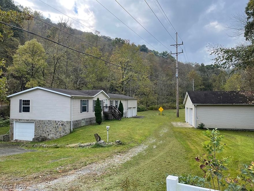 Lovely remodeled manufactured  home on a  full basement. Nice open floor plan very open with lots of light.  Master suite with seperate  soaking tub and shower.   3 different areas to park cars.  A absolutely huge attached built on 2 car garage.  This garage is oversized and  would most likely  park more than two vehicles.  A 4 car detached garage that has been rented out previously and a two car basement garage.  The upstairs was recently remodeled and there is an extra furnace in the basement that has not been hooked up.   The owner will leave the extra furnace if one desires.  The main furnace is on the first floor.  A whole house generator located in attached garage.  Fireplace in the family room. New survey just completed byHamilton and Associates and approved by engineers office.    Seller will retain all mineral rights.