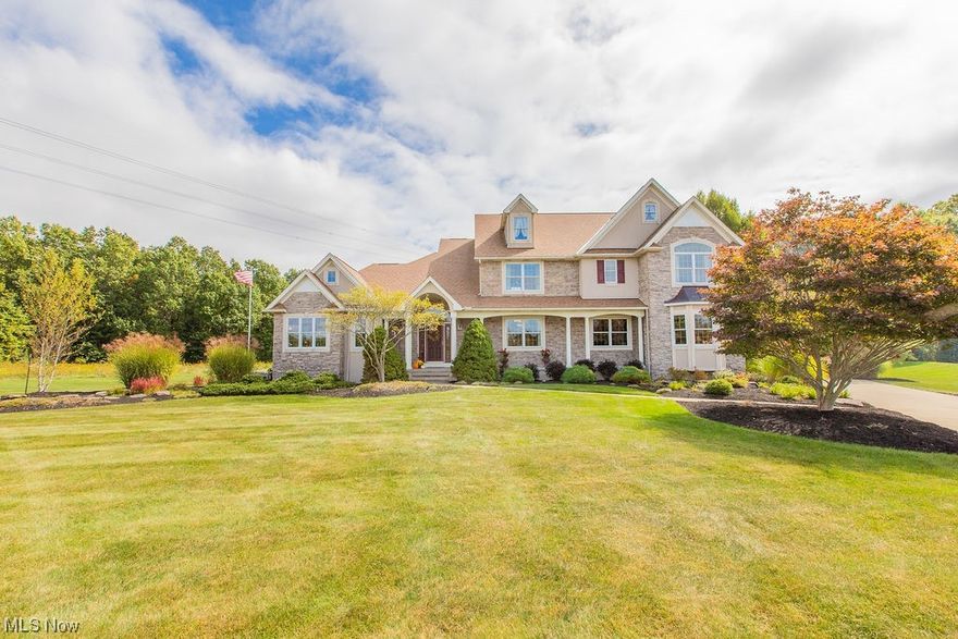 Welcome to this impeccably maintained custom-built home, nestled on 3.5 private acres in the beautiful Olmsted Falls school system.Railroad tracks behind the property create the perfect backstop for the shooting range.  Tracks and electric easement provide privacy and nothing can be built east or north of the property. Easement provides the perfect spot for a large garage or barn.  As you enter the home through the gorgeous foyer with its inviting curved staircase, you'll be greeted by a sense of elegance. The kitchen features stunning granite countertops & beautiful cabinetry. The great room, surrounded by windows, offers ample natural light and showcases a wood-burning fireplace. The family room as an additional FP.This home also offers the convenience of a first-floor bedroom with a full bath. Upstairs, you'll find the primary bedroom, complete w/ sitting area and connected office. The en suite bath includes a tile shower, a soaking tub, and his/her closets. Bedrooms 3 and 4 are expansive and each have their own bathrooms.The LL of the home features a fabulous theater room and a convenient half bath, creating the perfect space for movie nights and gatherings. Step outside to the covered patio with a fireplace and enclosed gazebo, offering a cozy and inviting setting for outdoor enjoyment.With a total square footage of 6044, this custom-built home offers ample space and a well-designed layout for modern living. This home provides quality and privacy at every turn.