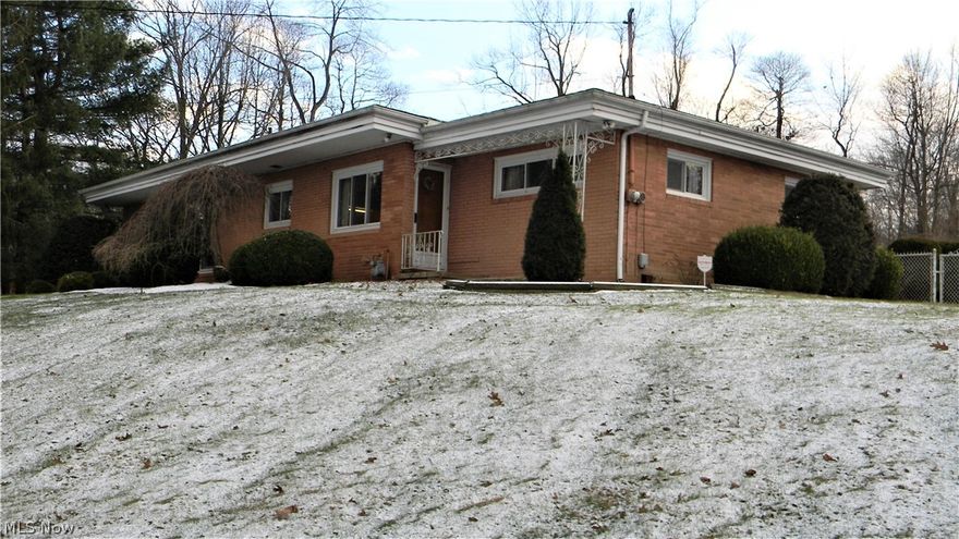 Move right into this welcoming brick ranch that sits on the corner of a dead-end street.  Home is on almost a half-acre lot that features an oversized 2 car attache garage and a separate 1.5 detached garage for cars, toys, or a shop with extra parking pads.  A nice chain link fenced area is perfect for pet containment.  A private front porch to sit and relax plus also a convenient rear patio and deck for entertaining and summer cook-outs. Many updates including vinyl windows, new roof, hot water tank, water softener, all 1st-floor carpeting and fresh paint with neutral colors.  The huge living room features an awesome custom stone wood-burning fireplace with built-in cabinets on each side and extensive windows to view the peaceful front yard.  The spacious kitchen has white-washed cabinets with a breakfast bar that leads to the dining room.  There are a first-floor master bedroom and two other ample size bedrooms with an ADA compatible walk-in tub/shower.  An ADA ramp at the back door