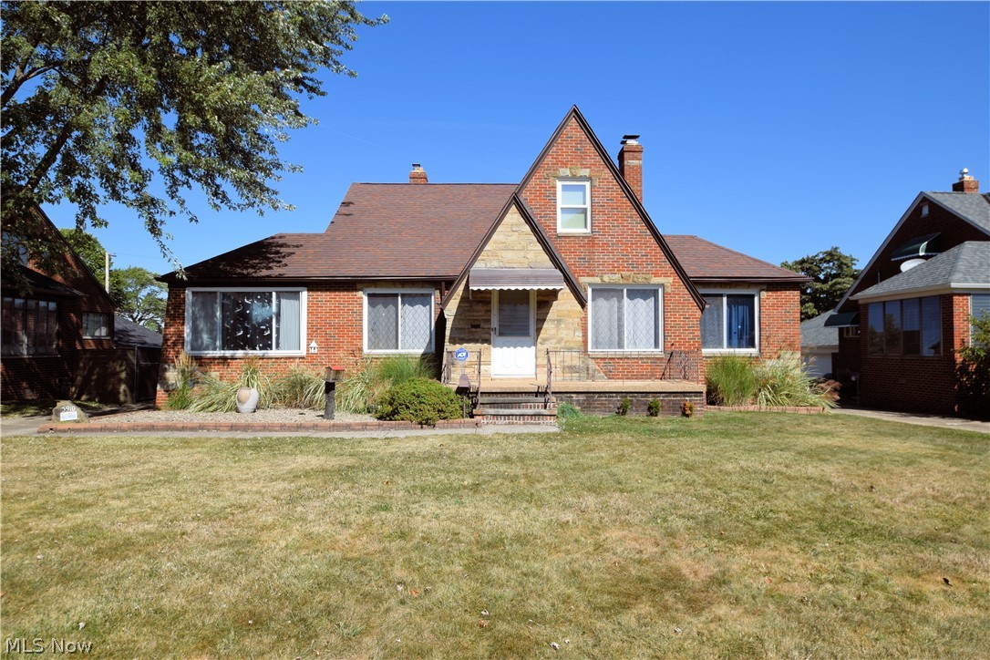 A true gem! This brick beauty is spacious and well maintained on a desirable street full of personality and charm! The front nature stoned porch welcomes you into this wonderful home. Gleaming hardwood floors throughout most of the home, adjoining dining room and living room with wood burning fireplace. Off the dining room is a sun room complete with hot tub! The eat-in kitchen has been updated with newer appliances, granite tops and ceramic flooring! There's a large room perfect for another sitting room, office or playroom off the living room. Main floor bath is wheelchair accessible and recently remodeled. A huge dormer offers storage and closets aplenty and two generously sized room, and a half bath! An attached garage enters through the basement or side door entry up wooden ramp in covered all year round heated canopy. Privacy fenced-in back yard perfect for everyday enjoyment & all your entertainment needs! Basement offers a large workshop space with nature stone flooring, 1/2 bat