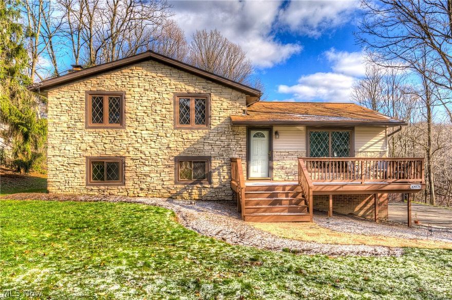 Move Right In to this Fully Updated Split Level Home! ***Check Out the 360 Degree Panoramic Virtual Tour!***Light and Bright First Floor Living Room has been Freshly Painted and Features Newer Flooring! Gorgeous Open Concept Gourmet Kitchen Remodel with Newer Cabinets, Butcher Block Countertop, Custom Tiles Backsplash, and Appliances! Lower Level Family Room with Brand New Carpet, Beautiful Stone Fireplace, and Sliders to Backyard! Updated Full Bath with Newer Flooring and Fixtures! Three Bedrooms on the Upper Level have been Freshly Painted and New Carpet Installed! Additional Remodeled Full Bath on Upper Level! Large Deck Overlooks an Acre+ of Wooded Land! Two Car Attached Garage as well as an Additional 32x40 Detached Garage, Ideal for Car Enthusiast, Landscaper, or Hobbyist!  New Septic Installed 2015! Newer HVAC and Electrical! Home Warranty Included! Call For Your Private Showing Today!