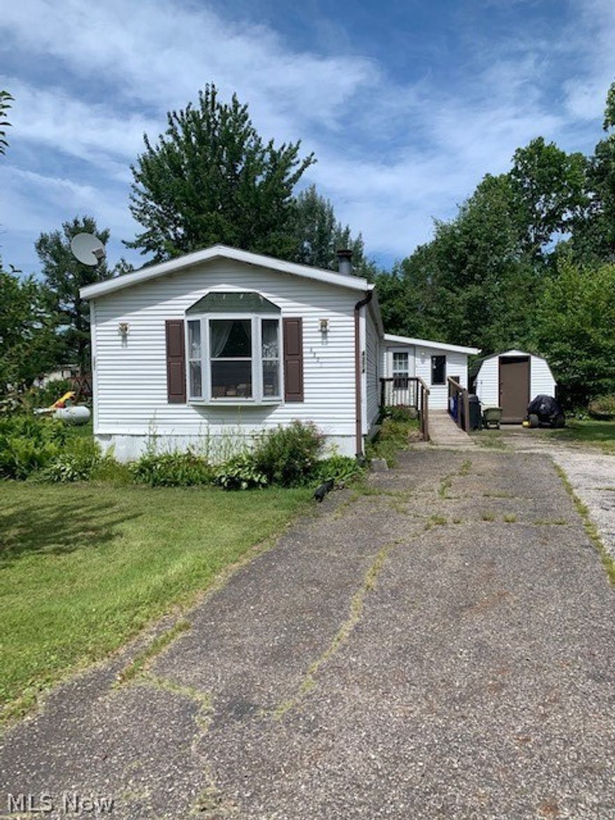 Spacious 2 bed home located in Valley Hill Estates! A large attached sunroom is the first room you enter. A handicap ramp is in place for a new owner to keep or tear down.  Enter into the spacious fully applianced kitchen which is loaded with tons of cabinets for storage. The kitchen overflows to a vaulted living room with a wood burning fireplace. The bedrooms are split to either side of the home.  Off the living room, you will find one bedroom at the front of the home and a full bathroom in that first hallway.  If you go back thru the kitchen, you will pass the laundry room to the left and continue on to the main bedroom which has its own bathroom which included a soaker tub and a separate shower. All rooms are vaulted and there are some skylights.  There is a deck off the sunroom, however, it will need repairs.  The owner was in older health and was not able to maintain the vegetation around the home. The back yard is large and semi private as it backs up to woods/ stream!!  Super p