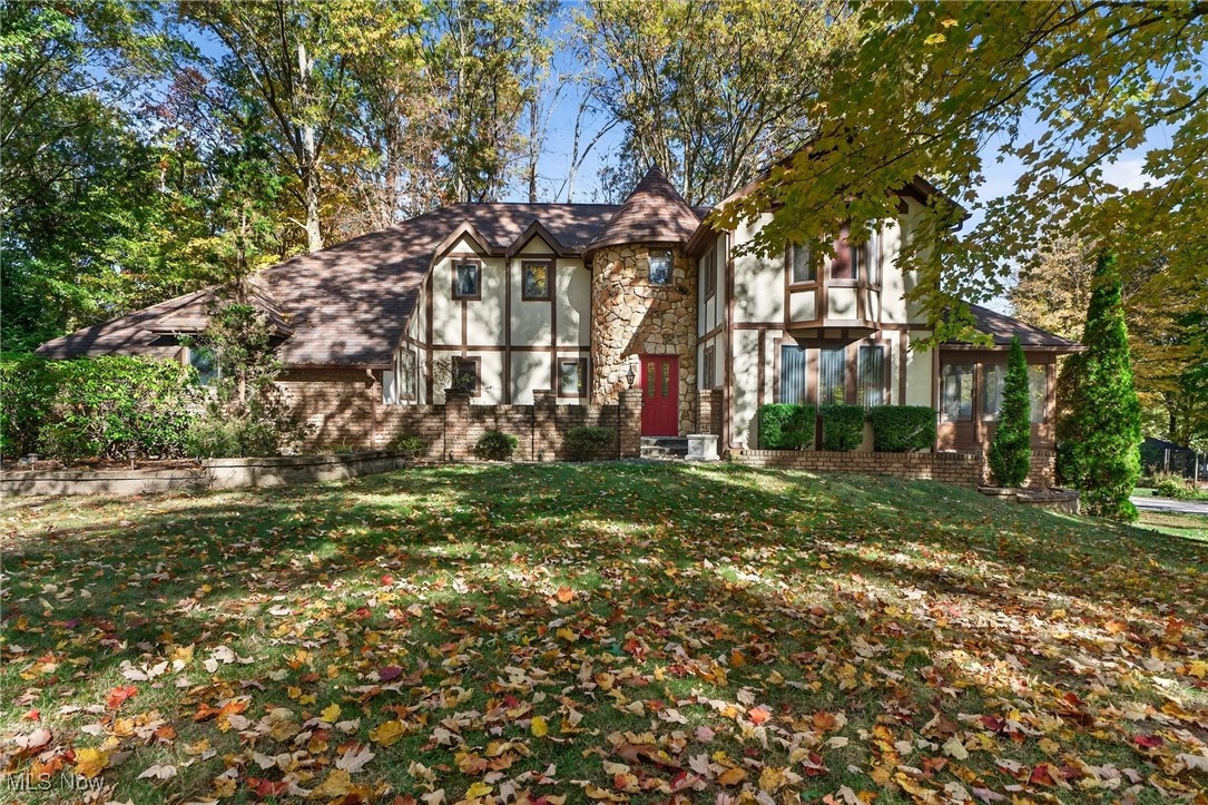 The property at 1585 Kent Street in Kent, Ohio, is a well-maintained, owner-occupied single-family home built in 1981. It spans approximately 2,518 square feet above ground, with an additional finished walk-out basement. The home features three very spacious bedrooms, multiple living and dining areas, two full baths, one half-bath, and two three-season rooms. It also includes two attached two-car garages, a concrete driveway, and essential utilities like well water and city sewer. The property sits on about 0.40 acres across three parcels. The main takeaway is that this is a spacious, Tudor-style residence with ample living space, functional features, and multiple amenities suitable for family living.