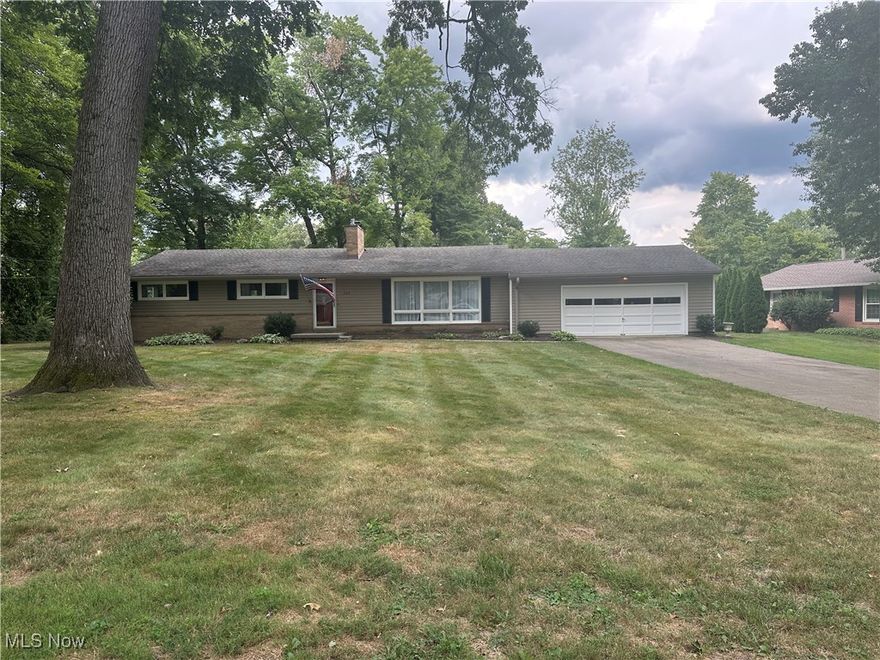 BROKER/AGENT-OWNED. Surprisingly spacious ranch within walking distance of Historic Downtown Hartville!  The open layout boasts a large kitchen with granite countertops, formal dining space and two living areas with floor to ceiling picture windows providing lots of natural light.  The first floor also includes a cozy primary bedroom with attached bath, two additional bedrooms, with a primary bath. The huge, finished basement provides a third gathering area, with hook ups for two TVs and surround sound. A full third bathroom, office, laundry room and exercise room/guest area with a murphy bed. Indoor spaces include two wood-burning fireplaces (one on each floor), the main floor fireplace has gas logs that can heat the first floor with efficiency, built in shelving and a two-car garage that can hold an F250 and has extra shelving for additional storage. There is also a closet in the garage for access to additional storage above the garage and storage in the closet as well. The charm only continues outside on the big private cement patio that looks out into the back yard.  Whether you're relaxing with family or hosting a party, the possibilities are endless with so many livable spaces! you do not want to miss this roomy, move-in-ready gem tucked back in a quiet, beautiful neighborhood.
Upgrades in the last 5 years: facia, spouting, well pump, furnace, A/C, garage door opener, 3rd bathroom, office, fireplace hearth, granite counters w/tile backsplash, finished basement (flooring, drywall, ceiling, lighting, insulation, electrical, plumbing fireplace hearth, and cabinets.  Updated in the last 5 years: kitchen and 2 bathrooms, laundry room.