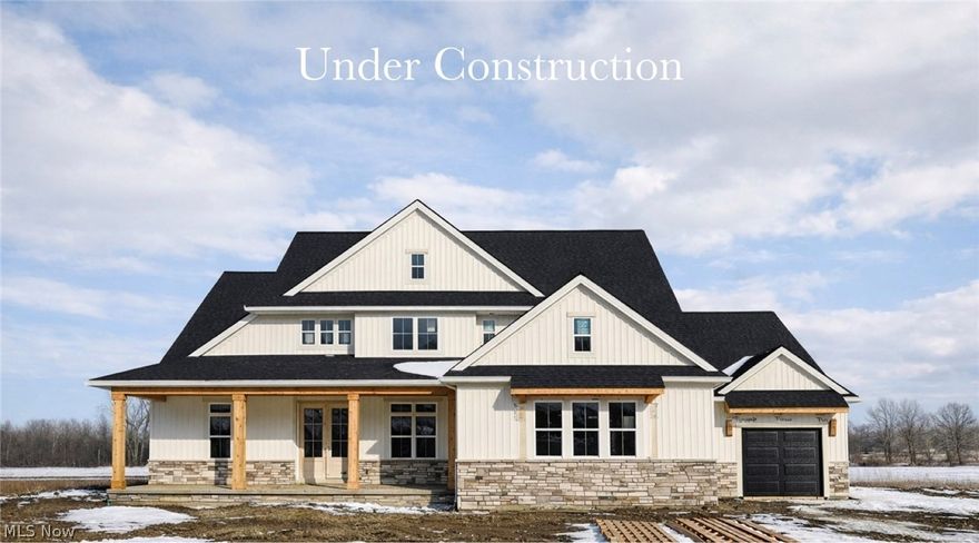 This thoughtfully designed home with 1st-loor primary suite, 3.5 car garage, and spacious covered outdoor living space just over the Westlake border is under construction for a Spring of 2026 move-in!  The expansive front porch, board and batten siding, stone wainscoting, and 8' double door entry bring loads of curb appeal and a warm welcome to owners and visitors alike. The private study with 8' tall double doors offers a stately work-from-home space, and the spacious 2-story great room with cozy fireplace and beautiful window wall provides an open and airy feel. Upscale finishes bring the wow factor to the kitchen with an almost 10' long quartz island, Bosch appliances, and upgraded ceiling-height cabinetry with dovetail construction, soft-close doors/drawers, and walk-in pantry.  The large casual dining space opens up to the oversized rear covered porch, perfect for entertaining or dining alfresco on warm summer evenings.  An organization station off the kitchen is ideal for keeping clutter and electronics off kitchen counters and in their own dedicated space, and the expansive mudroom with built-in lockers and private covered entry from the exterior makes it easy for those coming and going.  A powder room and large laundry room with built-in utility sink complete the first floor.  Upstairs, you'll find 3 additional bedrooms, each w/ their own walk-in closets, and two full baths, one ensuite, and one Jack & Jill with separate sinks for added privacy.  The full basement boasts 9' ceilings and is roughed in for both a full bath and wet bar for future finishing. Conveniently located less than 3 minutes from I-90 and less than 3 miles from Crocker Park, this location makes for stress-free commuting and offers a plethora of dining and entertainment options in both Westlake and Avon. Photos are for illustrative purposes as home is under construction.