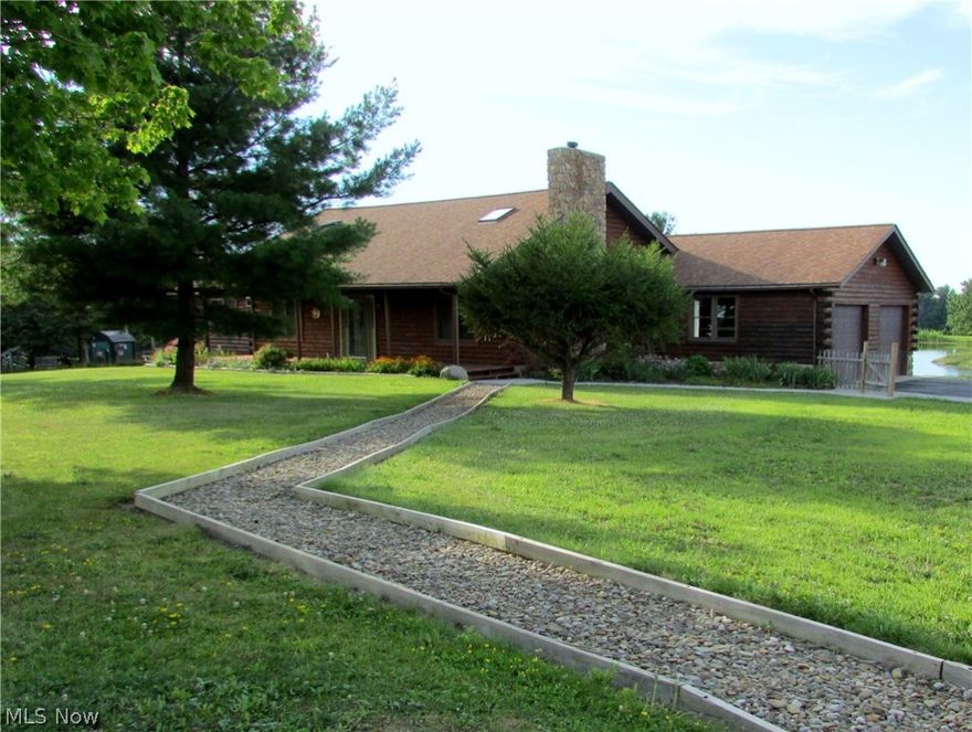 Escape to the tranquility of the country in this 3 bed 3 bath Log Home on almost 8 acres! A peaceful setting, gorgeous waterfront views, and park-like lot await you! Enjoy summer days where you prefer: there's a covered front porch, large back deck, 2-tiered patio with firepit, and even an island in the 2+ acre pond! The entire lot is fenced in & there's a barn with stalls, electric/water hookup, hayloft, and wood-working shop! Charm & character abound in this ranch style home with 16x16ft loft, vaulted ceilings, an open layout & updated kitchen & baths. Relax in the spacious living room & cozy up to the wood burning fireplace with Vermont Casting, stone surround, & rustic barn beam mantle. The kitchen includes all appliances, and a breakfast bar open to the dining room. A spiral staircase leads to the loft which overlooks the main floor with exposed beams & skylights for natural light. The Master Suite is complete with vaulted ceilings, plenty of closet space, and a large bathroom with jetted tub, tiled shower, & ceramic flooring. 1st floor laundry room has close accessibility to all 3 bedrooms. The full walk out basement is unfinished and awaiting your personal touches! It includes a full bath, workshop, framed in 4th bedroom, and a spot that's ready for a pellet stove with a stone hearth and ventwork. Everything has been well maintained or updated: water tank '14, windows '12, septic cleaned '12, well cleaned & new pump installed '11, water softener & pressure tank '05.