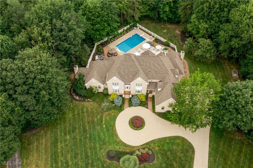 Tucked away at the end of a quiet cul-de-sac, this extraordinary builder’s home is a rare fusion of timeless craftsmanship, innovative efficiency, and luxurious comfort. Custom built & impeccably maintained, the residence spans more than 8,500 square feet & sits on 2.66 private, wooded acres. Every detail has been thoughtfully curated, from the solid core doors & elegant crown molding to the radiant natural wood floors and heated 4-car garage. The updated chef’s kitchen shines & flows effortlessly into gracious entertaining spaces, including an inviting family room, formal living and dining rooms and butler's pantry, and a versatile main-floor suite perfect for guests, in-laws, or a private office. Beyond its beauty, this home is a masterclass in healthy, efficient living. It features hospital-grade air filtration and UV purification systems, a 7-zone high-efficiency HVAC system, and a comprehensive water treatment setup including iron filtration, softening, and pH balancing. Energy-conscious buyers will appreciate the R-21 rated 2×6 exterior walls, R-38 attic insulation, and Marvin low-E argon-filled windows. A generator with automatic transfer switch ensures year-round peace of mind. At the same time, advanced security & data systems—including CAT 5 wiring and an 8-camera surveillance system—offer exceptional connectivity and control. The walkout lower level transforms into an entertainer’s dream and wellness retreat with a full secondary kitchen, expansive recreation space, a dedicated gym with sauna, and a full bath. Step outside to your resort, where a heated saltwater pool with automatic cover promises summer after summer of low-maintenance enjoyment. A new Raypak 336,000 BTU heater was installed in 2024, and a 2024 roof with a 50-year transferable warranty offers durability & peace of mind for decades to come. Surrounded by nature yet close to every convenience, this home is a rare & compelling offering—equal parts sanctuary, showplace, and smart investment.