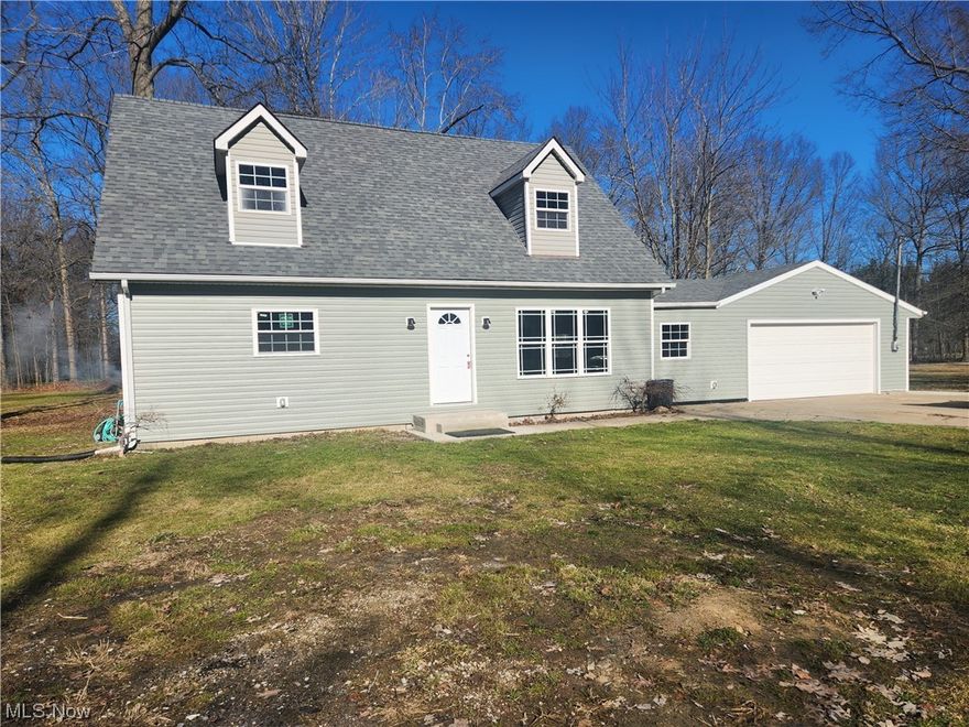 MUST SEE to believe.  Completely remodeled 4 bedroom 2.5 bath home on 7.5 acres.   The beautiful home sits back off the road with a mostly wooded lot.  Included is a 4 single bay and 1 double bay outbuilding with electric and gas for business or pleasure.  The outbuilding includes a loft room for entertaining or hanging out.  The house boasts a open floor plan with new electric, new roof, new plumbing, new HVAC, new water heater.  All new flooring, appliances and fixtures.  Attached two car garage.   First floor master bedroom with master bath.  A gorgeous soaking tub and walk in shower.   Walk in closet attached to walk in laundry.   Gorgeous wrap around stairs to 3 large bedrooms and large full bathroom.  Main floor has half bath and laundry room.  Long driveway provides privacy to house nestled on 7.5 acres.  Partially paved driveway to attached garage