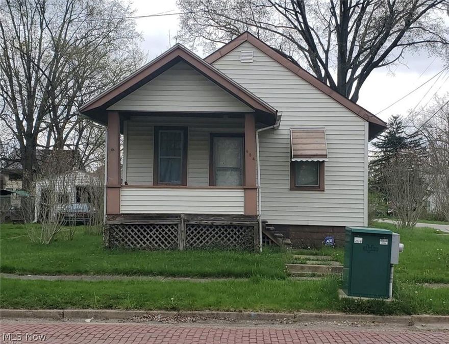 Quaint little ranch located on a quiet street, this home would make a great addition to your rental portfolio or a perfect little starter home. Just needs a little TLC. This corner lot home features two bedrooms and an additional room off the back, (Auditor lists as 3 bedroom) the back room would make a great office, small dining room or sunroom. The huge living room is big enough for living room and dining room combo. New flooring throughout. All NEW appliances that will stay with the home.  New kitchen cabinets, countertop and sink have been added since photos were taken. This home has a full basement and a large two car garage and shed in the back yard.  Schedule a private showing.