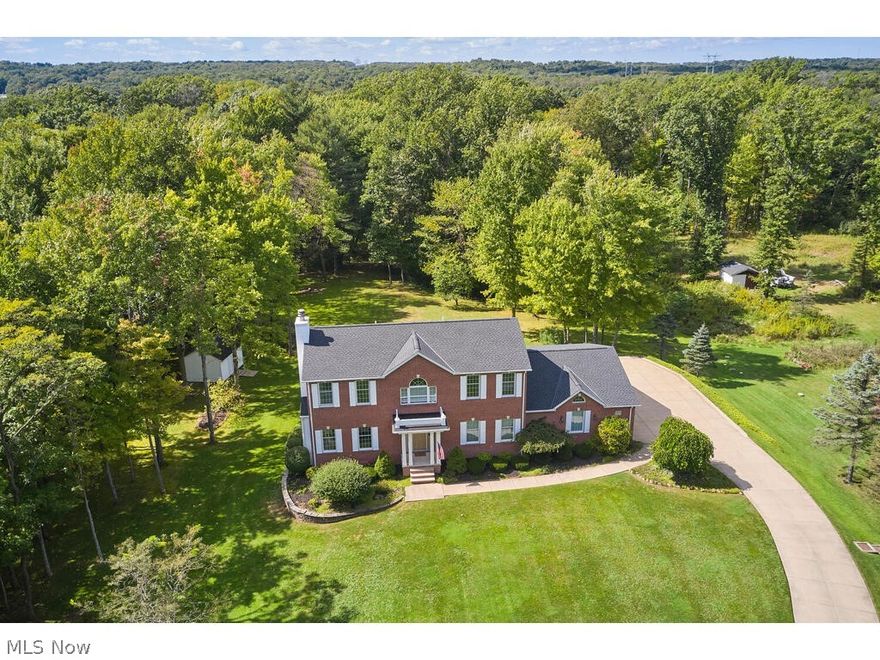 Impressive and stately, brick front colonial, nestled on 3.4 wooded acres, presents exceptional amenities and improvements.  Grand two story foyer features marble floors, open staircase, and chandelier w/winch for lowering.  Inviting great room hosts gas fireplace flanked by built-ins and wall of windows.  Gourmet kitchen offers Haas maple cabinetry, black appliances including new dishwasher, granite counters, pantry, Pergo flooring, and peninsula bar.  Kitchen overlooks expansive eating area w/slider to small deck/stairs to yard.  Adjacent full bath and large laundry room with sink, cabinetry, and two double storage closets.  FF owners suite highlights glamour bath w/double vanities, walk-in shower, Jacuzzi tub, and H/H closets.  Second floor boasts four generous sized bedrooms, two full baths, and catwalk to storage closet.  Wonderful finished walkout LL with family room, gas fireplace, 2nd kitchen w/eating area, exercise/multi-purpose room, full bath, ample storage rms., and much mo