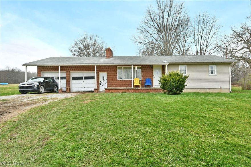 Potential, potential, and potential! This endearing Bristolville residence checks all the right boxes for a perfect project, ready to receive your creativity with its great bones and even better layout! Serving up everyone’s favorite ranch layout, the home ups the ante with a three-bedroom layout plus a full basement below with tall ceilings and a brick fireplace, allowing an easy opportunity for even more finished living space. Outside, the brick accents add to the covered, two-car garage and porch entrances, both with brand new and stylish entry doors. Rural surroundings ensure peaceful, scenic views as you make your way inside. A gracious living room enjoys a large picture window to introduce plenty of natural light. Take advantage of the impressive kitchen and combined central dining space as sliding doors open to the raised rear deck out back. A hidden pantry is located next to the garage access. Down the main hall, a brightly colored full bath is renovation-ready, while the trio of bedrooms completes the package to include a larger master with its own private half bath. Property is being sold "AS IS", "WHERE IS''. CASH ONLY! The seller is currently having the property re-surveyed and it will come with approximately 1.6 acres only!